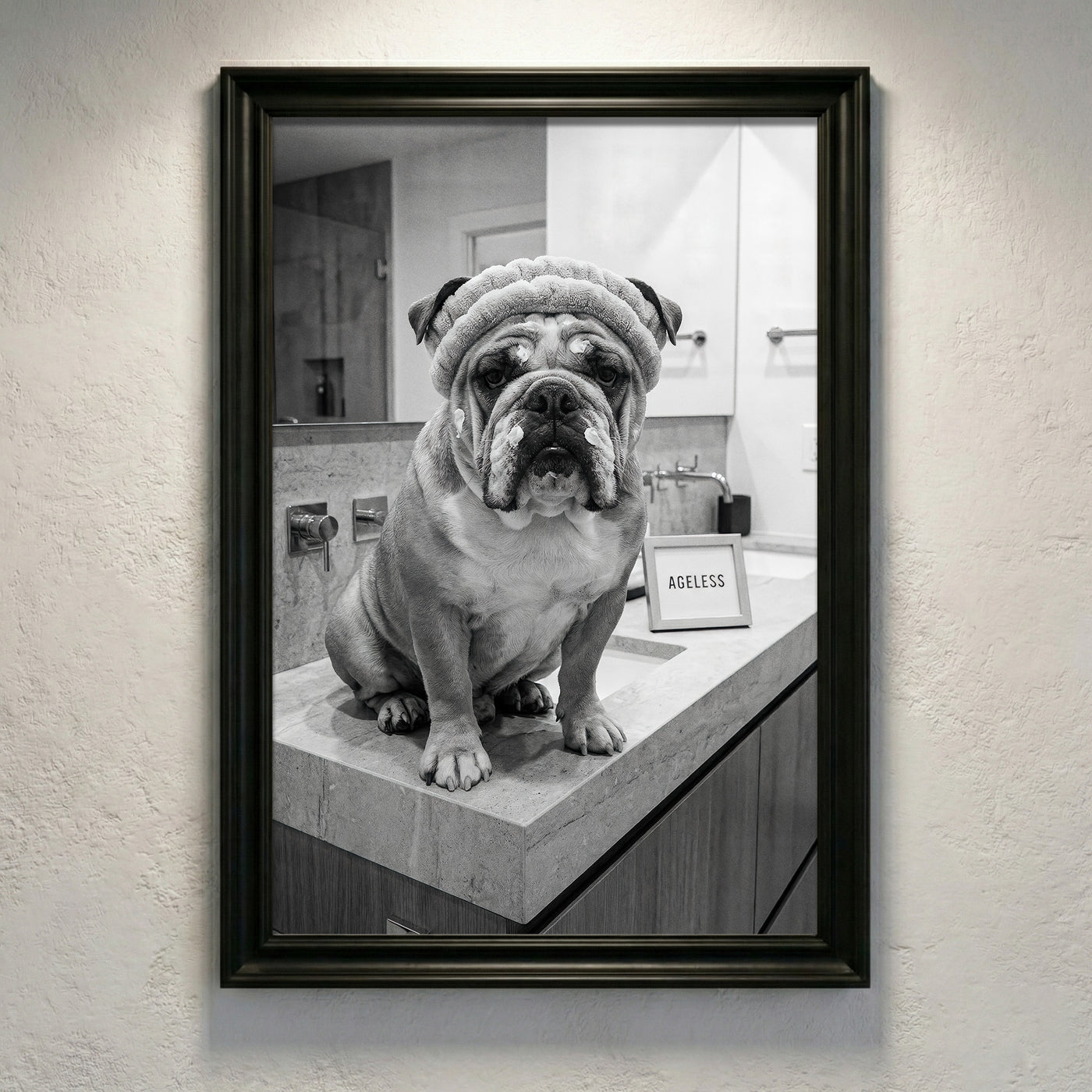 A crisp black and white photograph of a bulldog sitting on a marble bathroom counter wearing a spa headband and face cream next to a sign that says AGELESS, created by Artazyn.