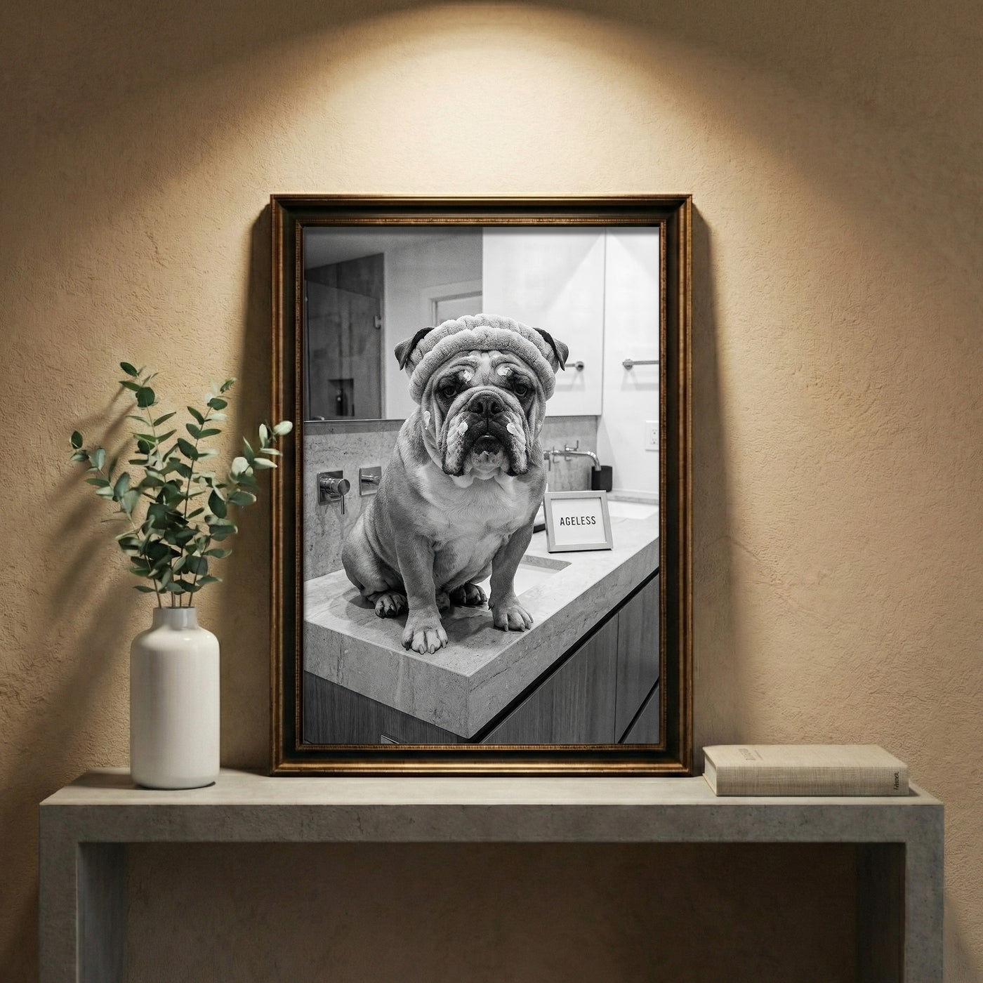 A crisp black and white photograph of a bulldog sitting on a marble bathroom counter wearing a spa headband and face cream next to a sign that says AGELESS, created by Artazyn.