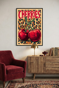 Retro pop art print featuring two large red cherries with green stems crossing against a leopard print background, with the word "CHERRIES" in bold red text.