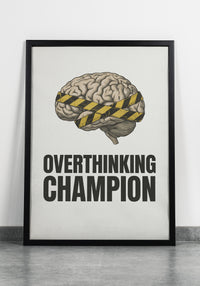 Framed poster with brain illustration and 'Overthinking Champion' text on a rustic wall.
